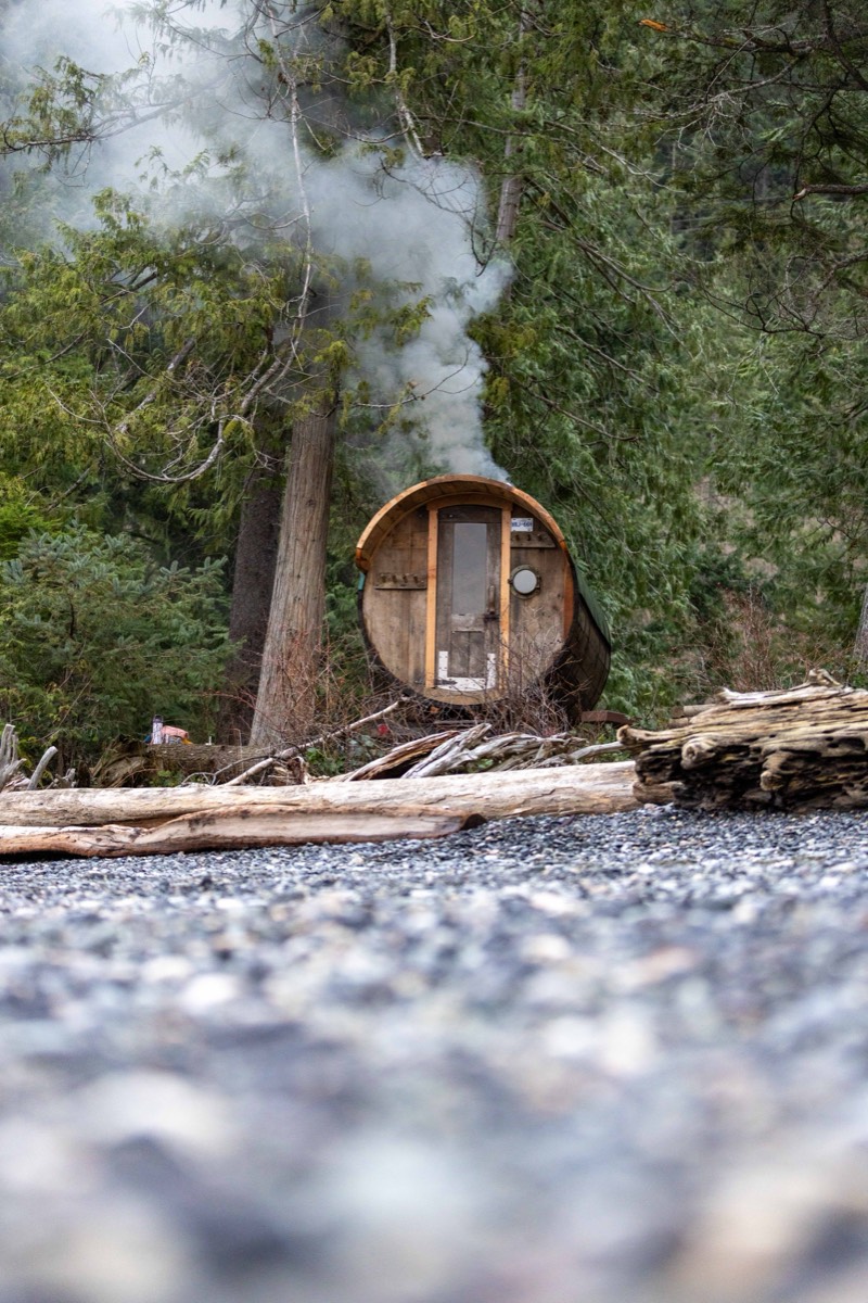 The barrel sauna set up beside the water