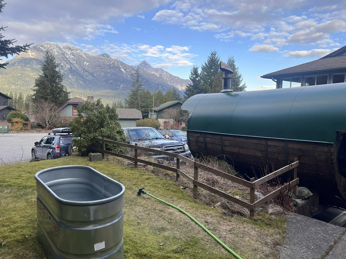 Mobile barrel sauna and cold plunge tub set up at a home in Squamish